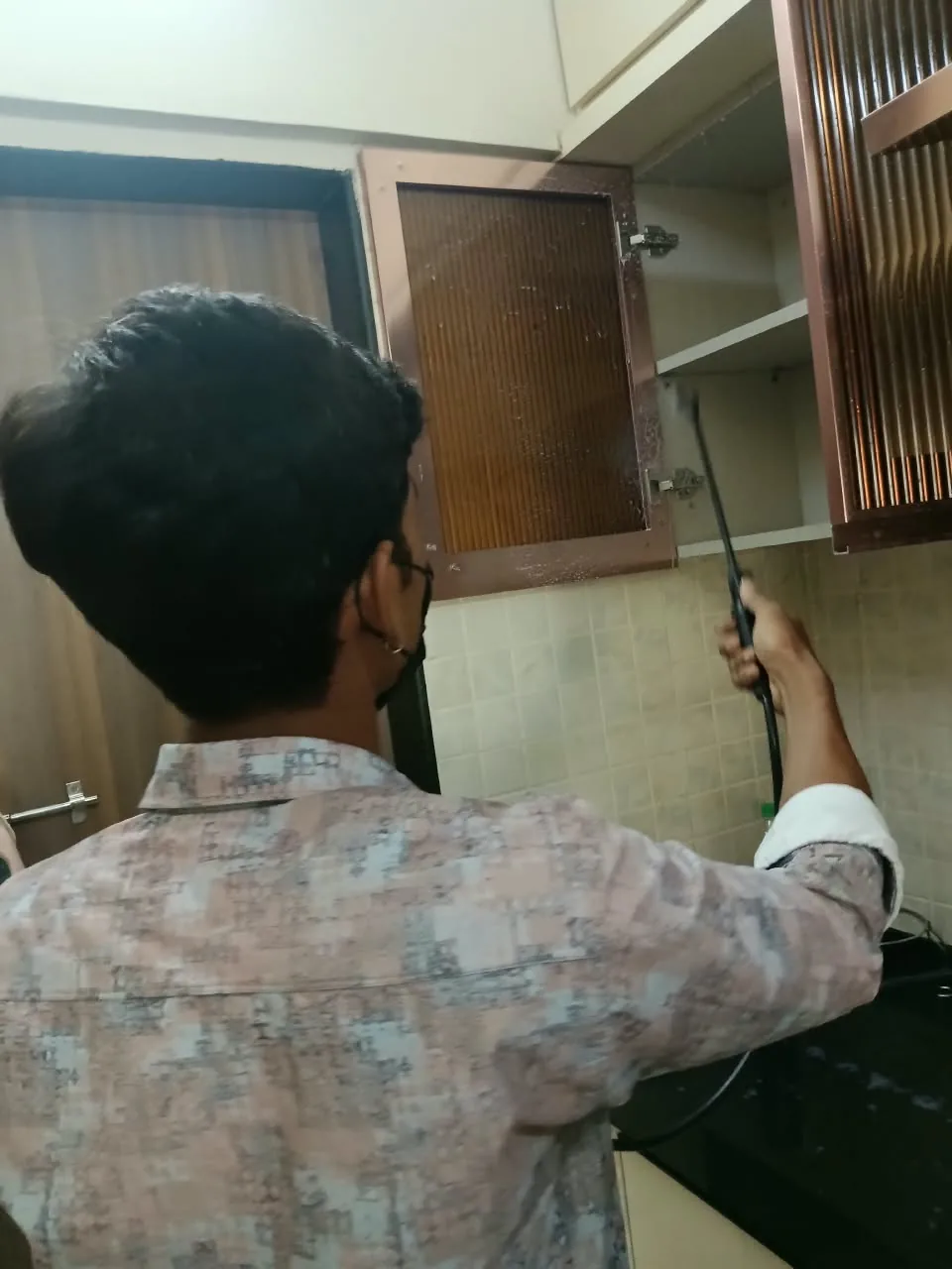 Real pest-control spray treatment in kitchen